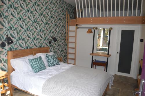 a bedroom with a bed and a wall mural at Grooms House in Hebden Bridge