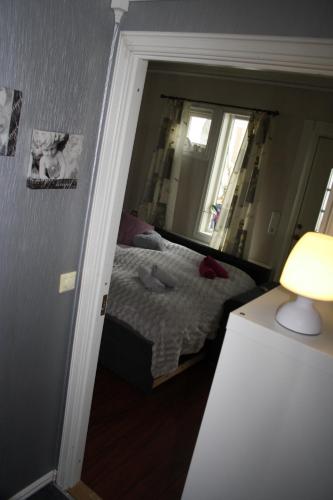 a small bedroom with a bed and a mirror at Huset på hauen in Volda