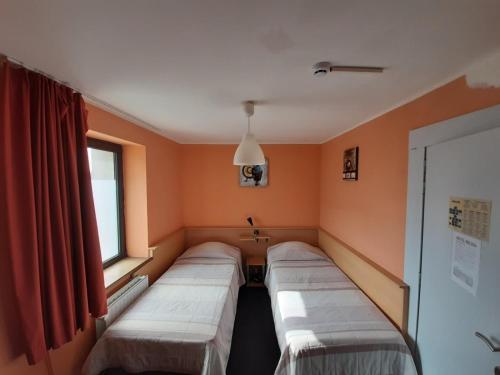 a row of beds in a room with a window at hotel Melissa in Péruwelz