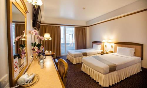 Postel nebo postele na pokoji v ubytování V.L. Hatyai Hotel