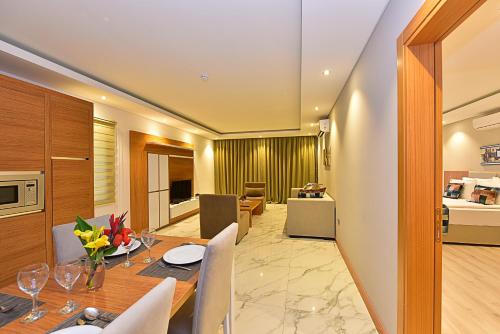 a dining room and living room with a table and chairs at Jasmin Elite Residence & SPA in Gümbet