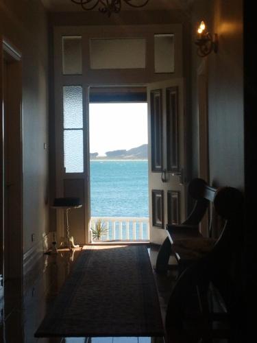 a room with a view of the ocean through a door at The Ark Stanley Luxury Bed and Breakfast in Stanley