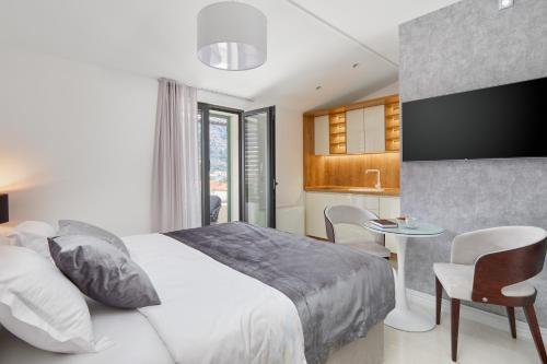 una camera con letto e tavolo e una cucina di Kotor Lux apartments and rooms a Kotor (Cattaro)