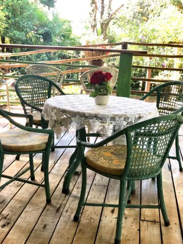 a table and chairs on a wooden deck at Villa da Serra Pousada in Piumhi