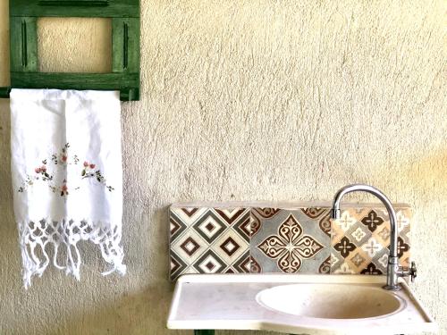 a bathroom with a sink and a towel at Villa da Serra Pousada in Piumhi