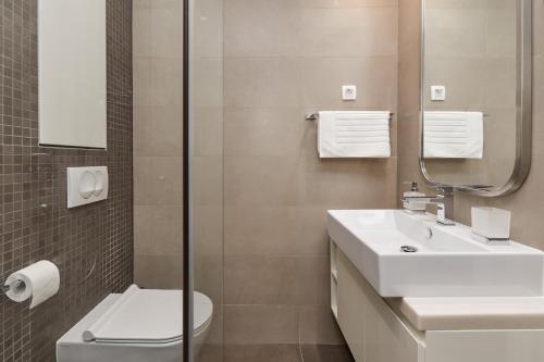 a bathroom with a sink and a toilet and a shower at Kotor Lux apartments and rooms in Kotor