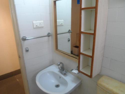 a bathroom with a sink and a mirror at Shanthiniketan - Ramoji Film City in Pedda Ambarpet