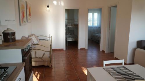 a kitchen and a living room with a tile floor at Home sweet Home in Metaponto