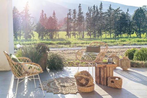 卡斯泰拉巴泰的住宿－BORGO DEL FRANCO，庭院设有藤椅和一张桌子,享有美景。