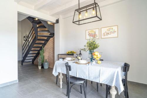 a dining room with a table and a staircase at BORGO DEL FRANCO in Castellabate