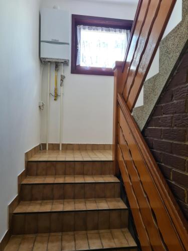a staircase in a house with a window at IN Pavlović in Banja Koviljača