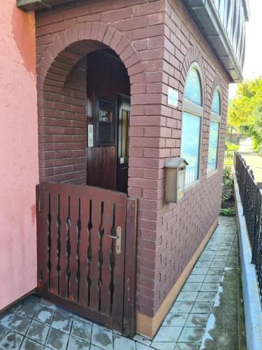 an entrance to a brick building with a door at IN Pavlović in Banja Koviljača