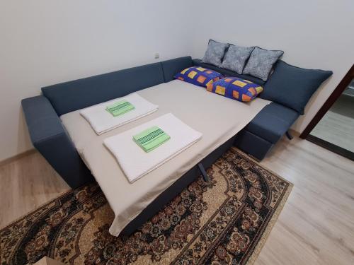a blue couch with a table in a living room at IN Pavlović in Banja Koviljača