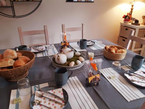 a table with some food and bread on it at B&B Caprice d'Epices in Francorchamps