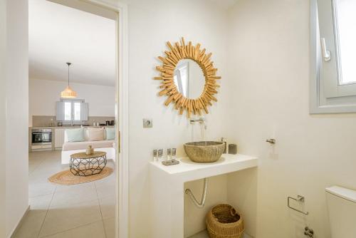 a bathroom with a sink and a mirror on the wall at DS Traditional Villas Santorini Island in Karterados