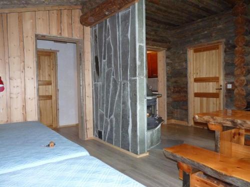 a bedroom with a large glass wall in a room at Karhujärven Kelopirtit in Karhujarvi