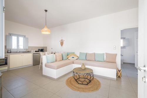 a living room with a couch and a table at DS Traditional Villas Santorini Island in Karterados