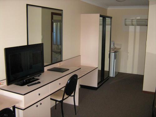 a room with a desk with a computer on it at Highway Inn Motel in Hay