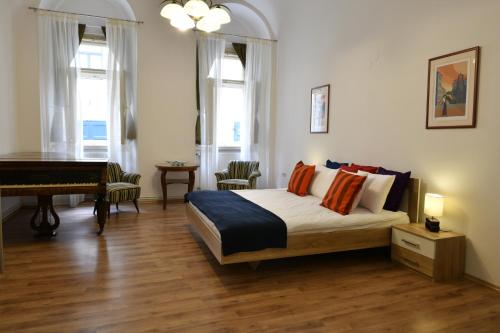 a bedroom with a bed and a piano at Apartment George&Dragon in Zagreb