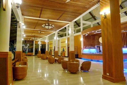 a lobby with a row of chairs and a pool at Pearl Laguna Resort in Myeik