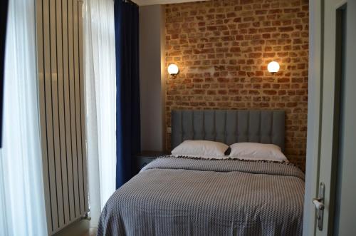 a bedroom with a bed with a brick wall at Benan Apartment in Istanbul