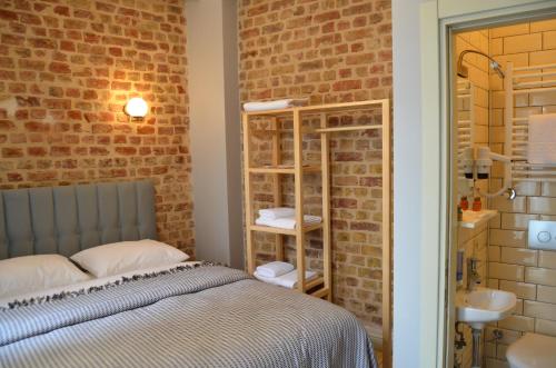 a bedroom with a bed and a brick wall at Benan Apartment in Istanbul