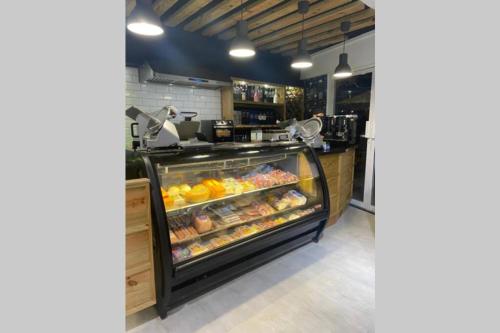 a bakery with a display case filled with food at Estancia Casa Real Frente a la Zona Colonial in Calero