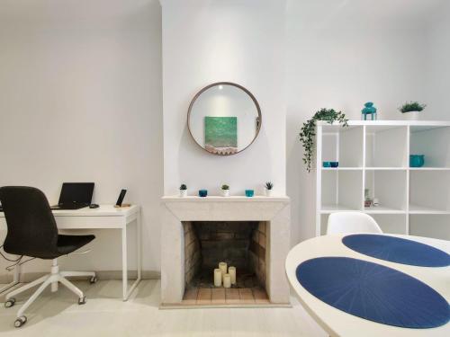 a white room with a fireplace and a mirror at Casa Sequeira in Albufeira