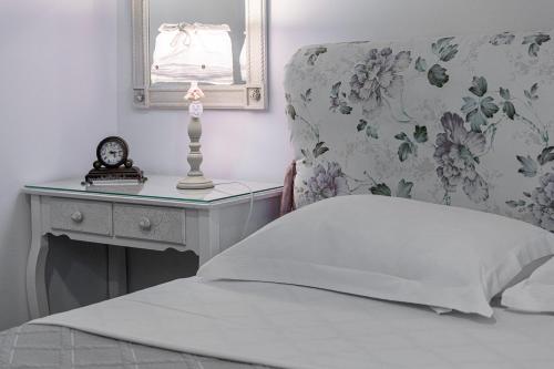 a bedroom with a bed with a table and a mirror at Comfort Stay Athens Airport Hotel - FREE shuttle from and to the airport in Spáta
