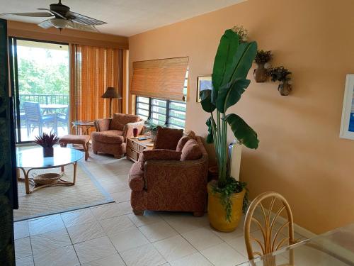 a living room with a couch and chairs and a table at Pelican Cove Condo in Christiansted