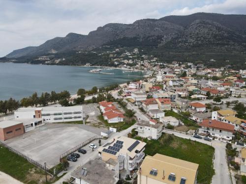 an aerial view of a town next to a body of water at Elenas Apartments in Plataria