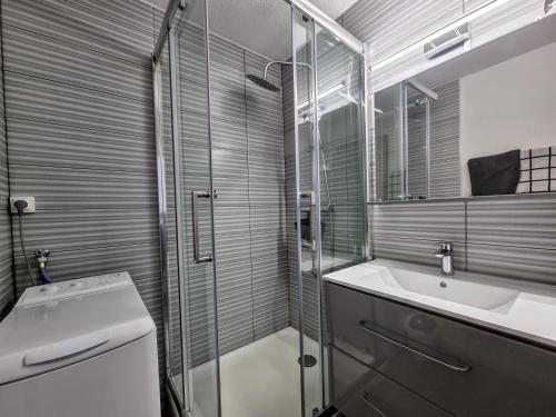 a bathroom with a glass shower and a sink at Appartement Banyuls superbe vue sur mer in Banyuls-sur-Mer