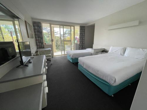 Ένα ή περισσότερα κρεβάτια σε δωμάτιο στο Parklane Motel