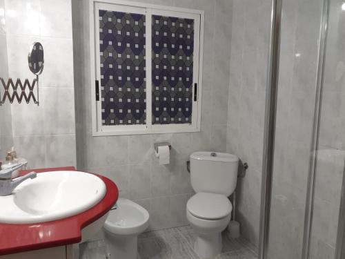 a bathroom with a toilet and a sink and a shower at Apartamento a 10 metros del mar in Cullera