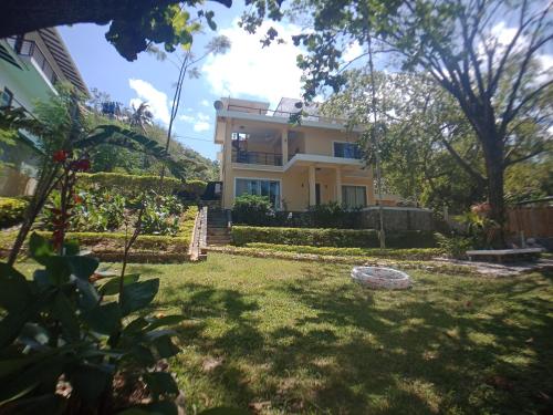 a view of the house from the yard at Amami Beachfront Villa with Private Beach in Puerto Galera