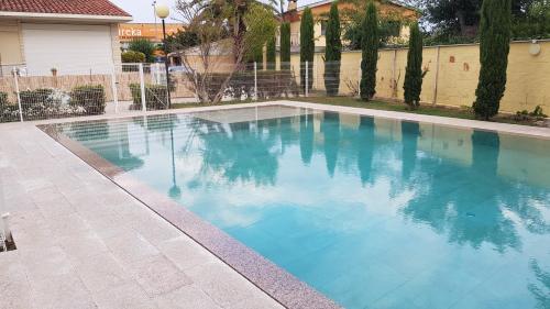 a swimming pool with blue water in a yard at Casa rural Villa Verde in Tudela