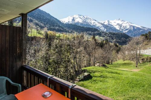 a balcony with a view of snow covered mountains at Hotel Derby in Fiesch
