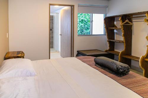a bedroom with a large bed and a window at Hotel Hacienda Buena Vista in Pueblo Tapao