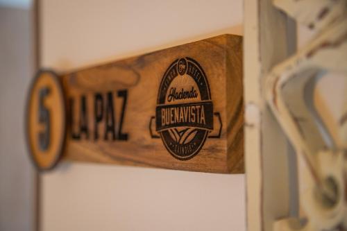 a wooden sign that reads durham durham basketball at Hotel Hacienda Buena Vista in Pueblo Tapao