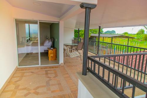 a balcony of a house with a view of a room at Hotel Hacienda Buena Vista in Pueblo Tapao