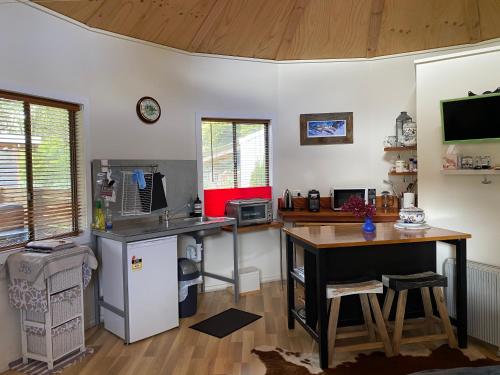 a kitchen with a desk and a counter top at Ionaforest Yurt in Wingello