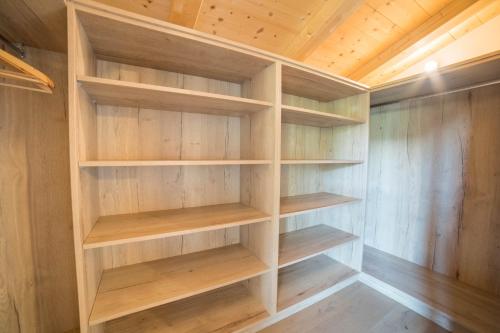a walk in closet with wooden shelves at Gasserhof - Chalet A in Frassinetto