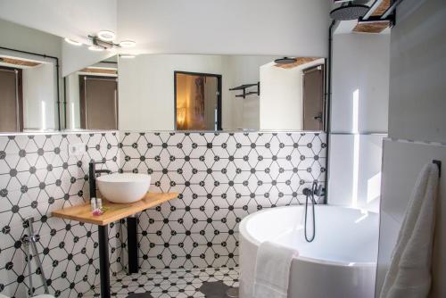 ein Badezimmer mit einer weißen Badewanne und einem Waschbecken in der Unterkunft Palacio San Fernando in Utrera