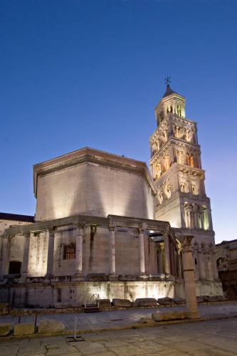 a building with a clock tower on top of it at Central Old Town Rooms in Split