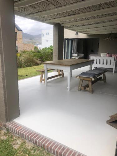 a picnic table and a bench on a patio at Pringle @ 865 Jally in Pringle Bay