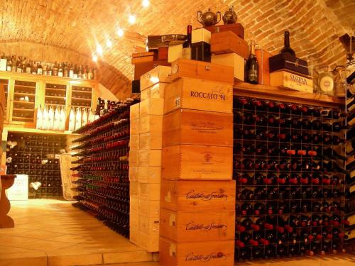 a room filled with lots of bottles of wine at Bed&Wine in Brisighella