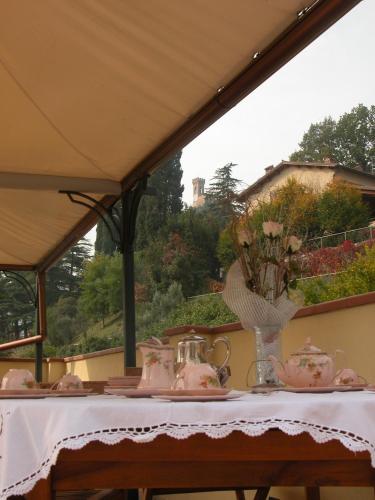 a table with tea sets on top of it at Bed&Wine in Brisighella