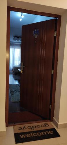 a wooden door with a welcome sign on it at Apartman Temida Lux in Vrnjačka Banja
