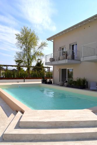 a swimming pool in front of a house at aura AR holiday-home in Peschiera del Garda