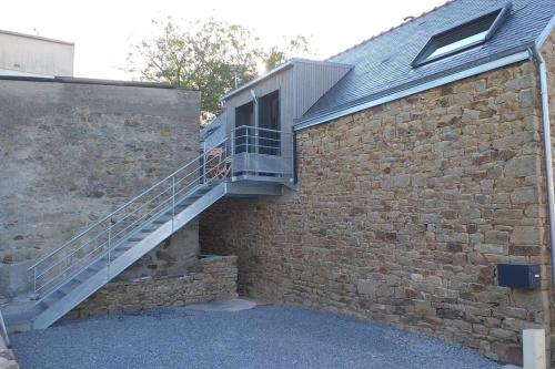 un escalier sur le côté d'un bâtiment en briques dans l'établissement Appartement dans un ancien corp de ferme, à Lorient